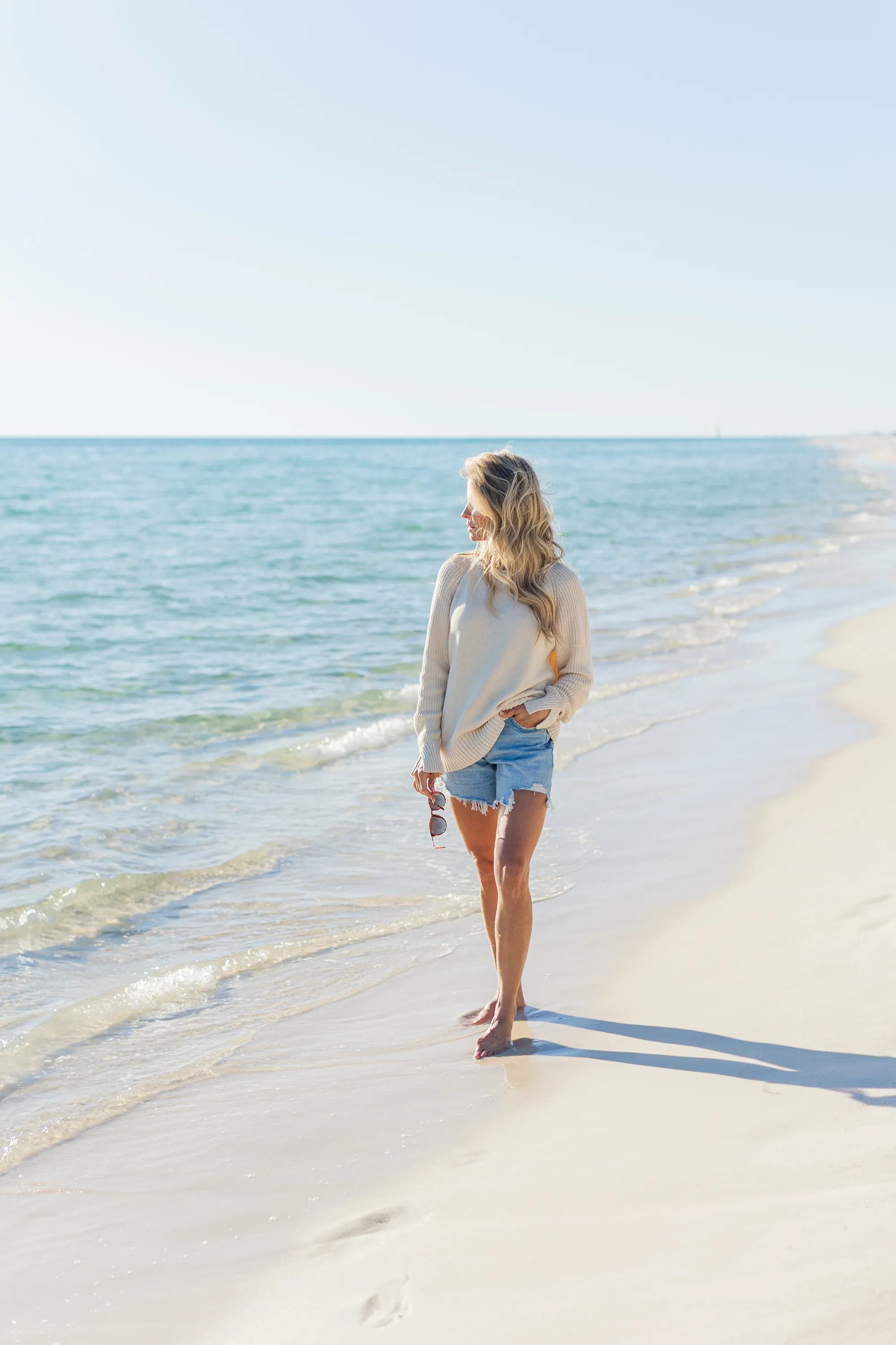 Heidi Powell walking along the shoreline at the beach